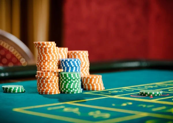 Live casino dealer table with cards and chips
